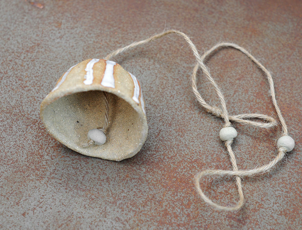 HAND PINCHED CERAMIC BELL - SANDY CLAY - WHITE DRIBBLE GLAZE
